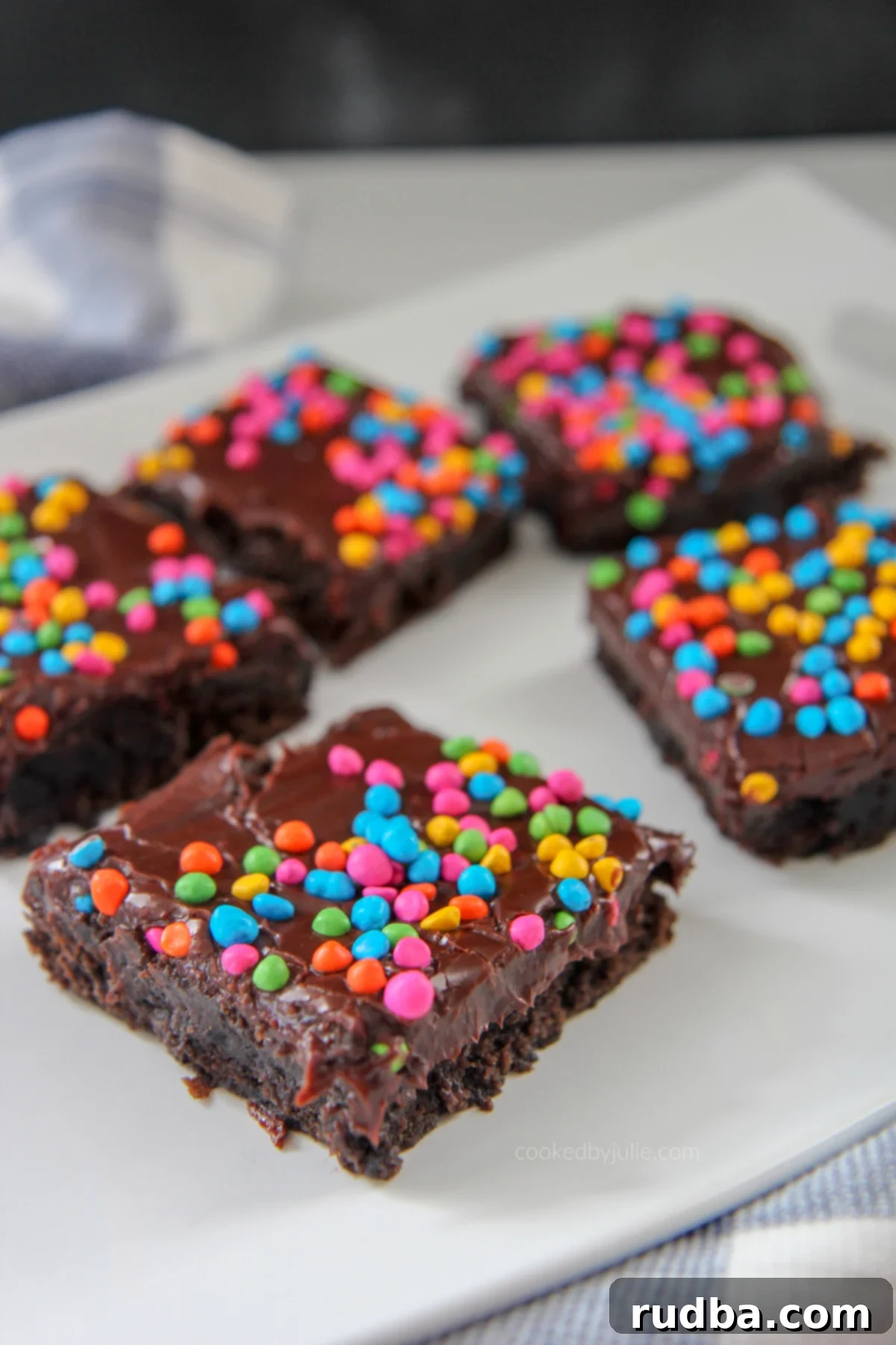 brownies with rainbow chips on top of a white plate