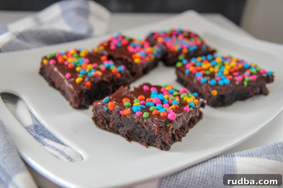 cosmic brownies on a white plate with a blue and white towel on the side