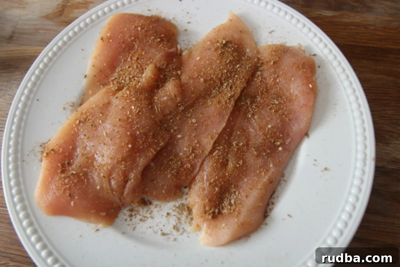 Step one is to season the chicken breasts before cooking.