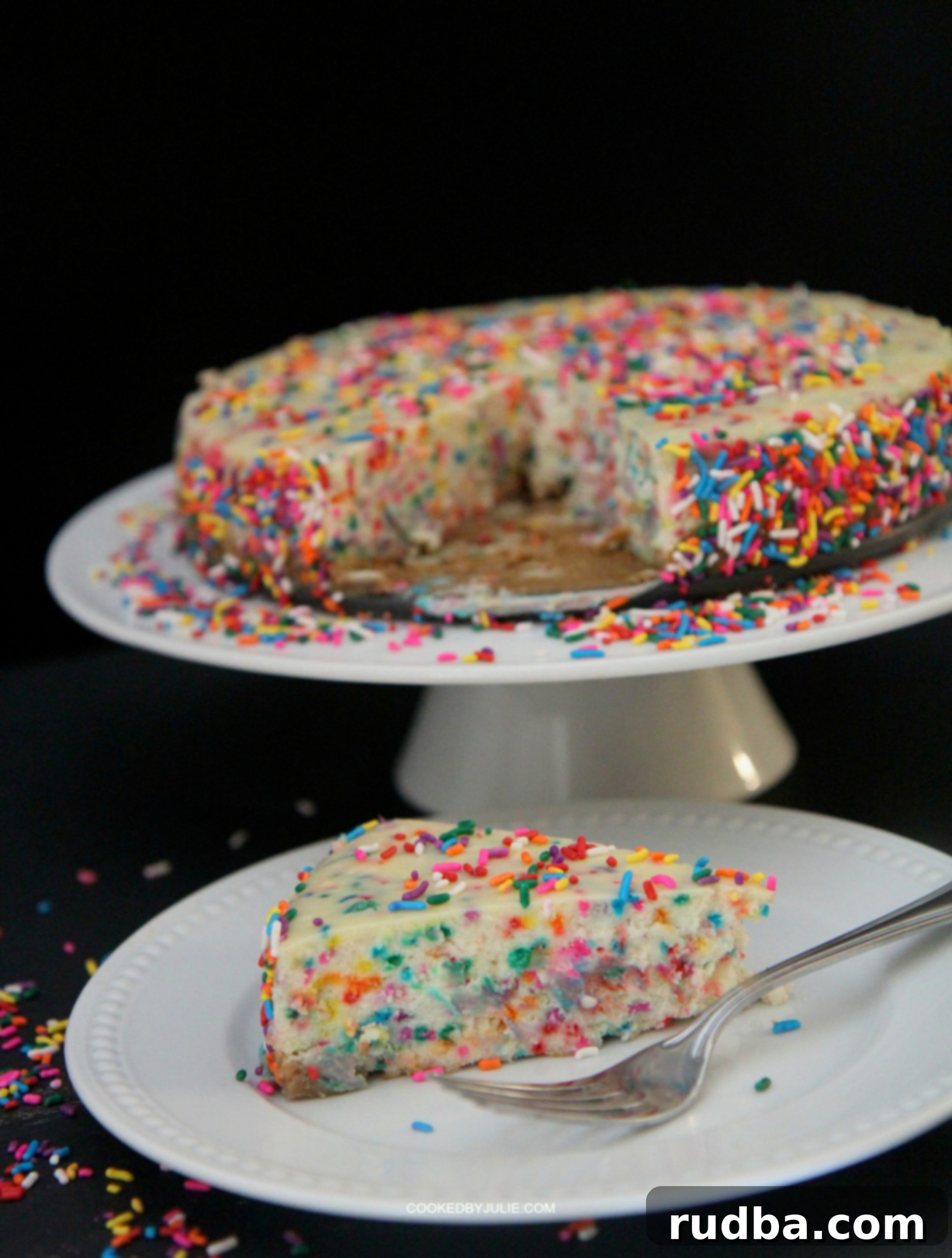 A vibrant slice of Funfetti Cheesecake adorned with rainbow sprinkles, ready to be enjoyed.