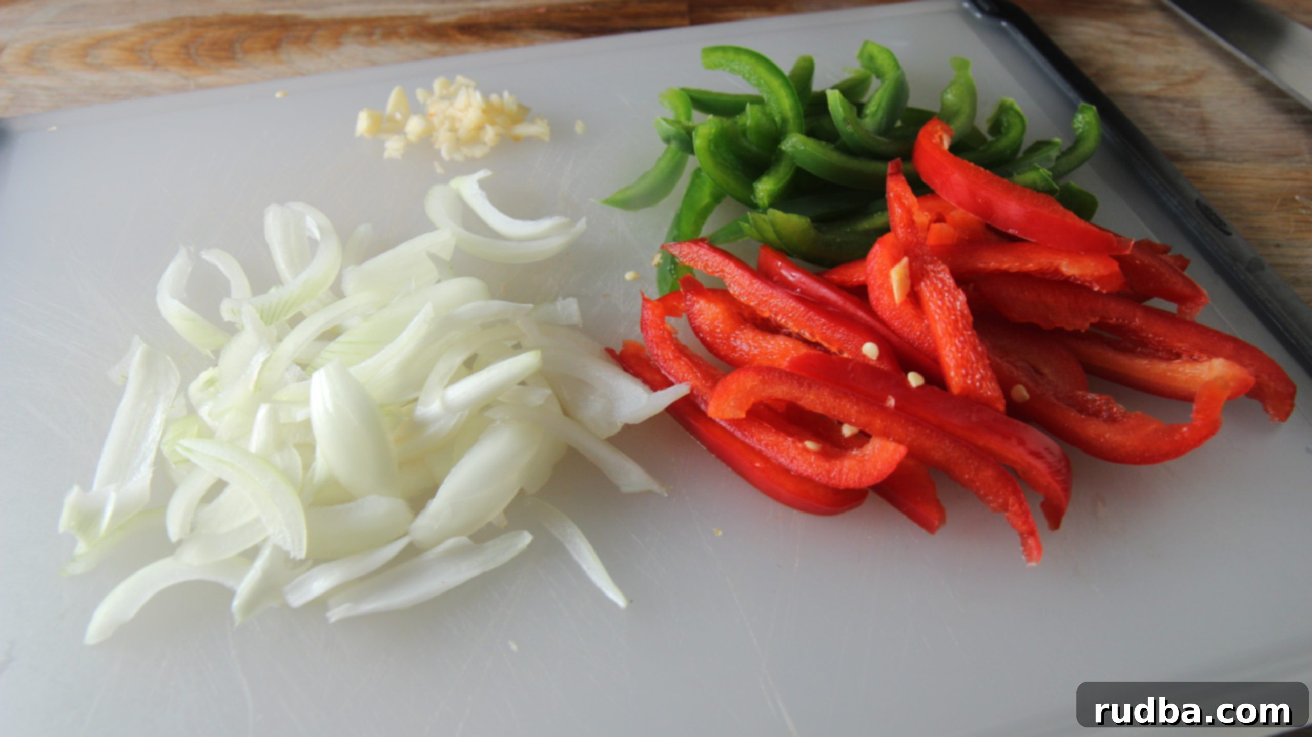 Chopped onions, garlic, and red and green peppers are the vegetables we need for our easy skillet cod dinner. 