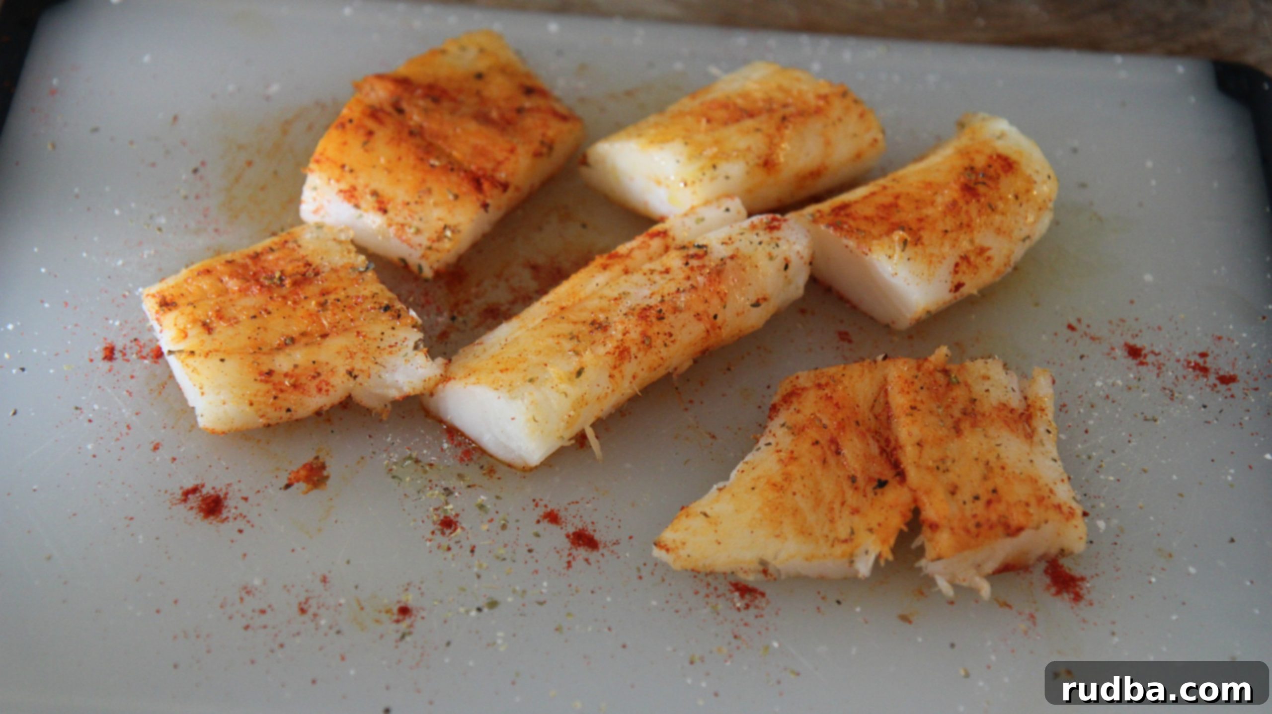 For this skillet cod dinner, you want to season your fish before cooking. Use a blend of spices you love, like chili powder for a little spice. 