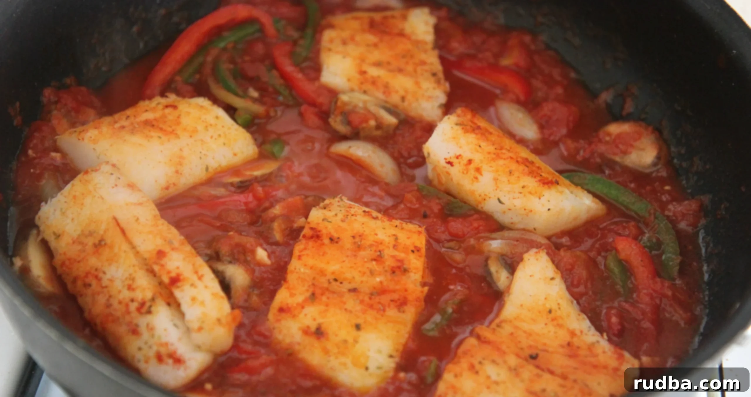 Cook the seasoned cod fish with your tomato sauce and vegetables for 12-15 minutes until fully cooked. 