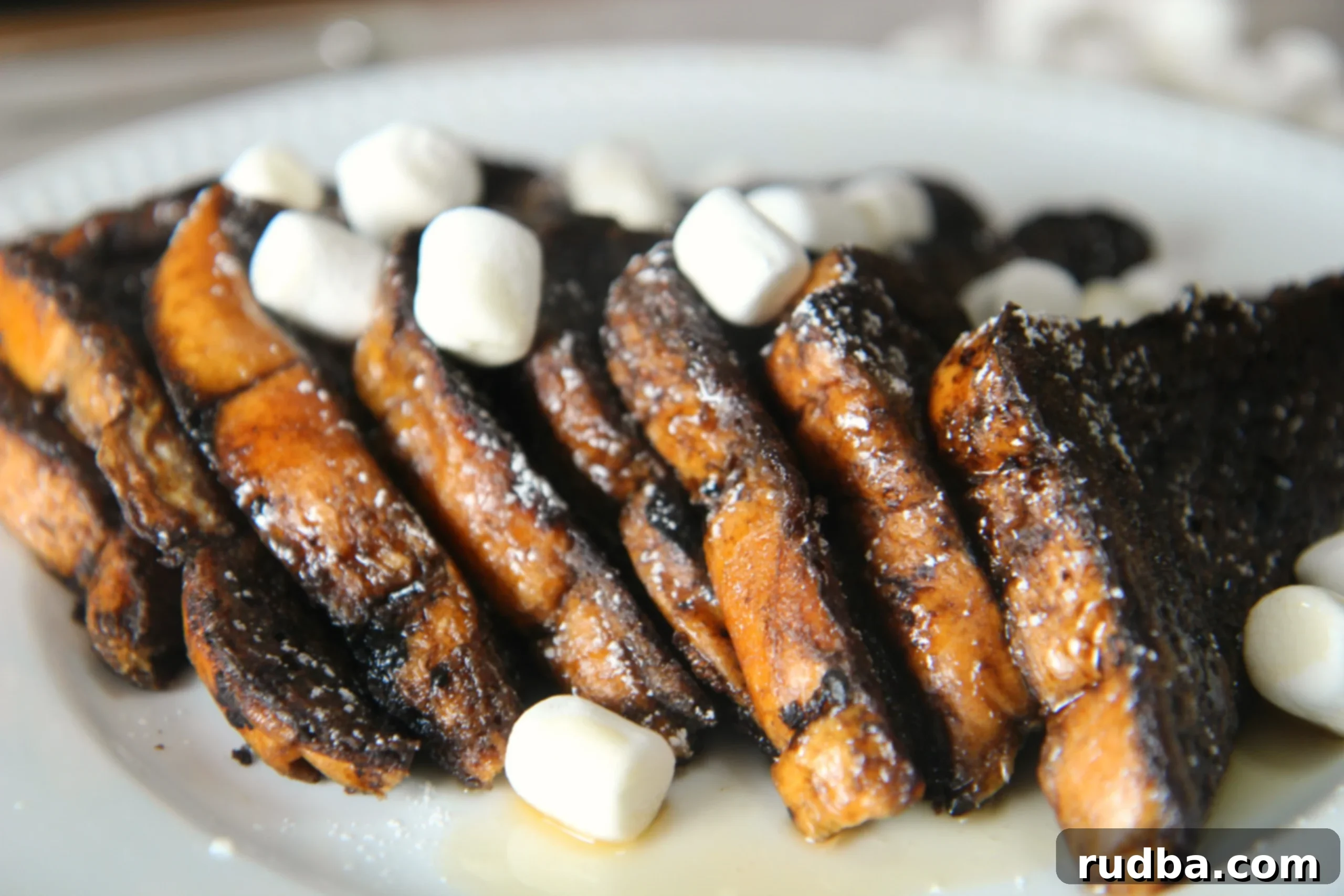 Fluffy marshmallows and melted chocolate topping golden french toast slices, creating a dessert-like breakfast.