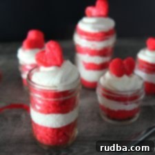 Irresistible Red Velvet Jar Cakes 9 Red Velvet Cake Jars are stacked with cake and frosting, ready for gifting.
