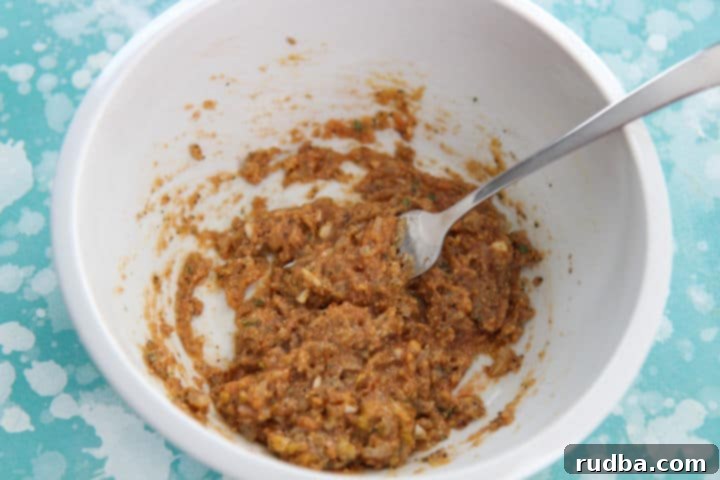 turkey meatloaf ingredients mixed in a white bowl with a fork 
