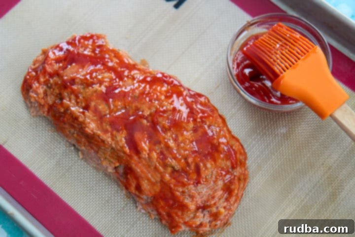 turkey meatloaf with a ketchup glaze on a baking sheet 