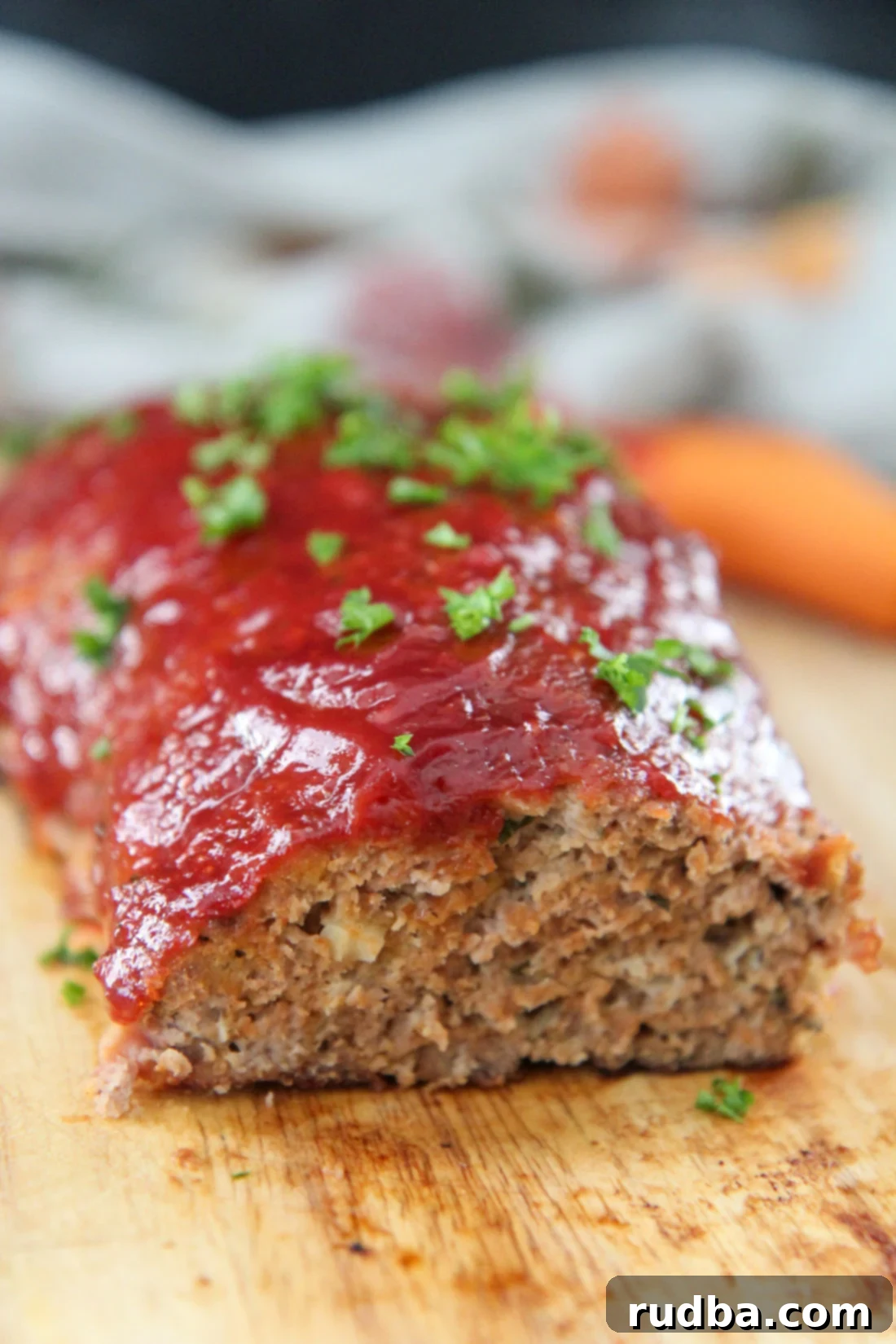 turkey meatloaf with parsley on top on a wooden board 