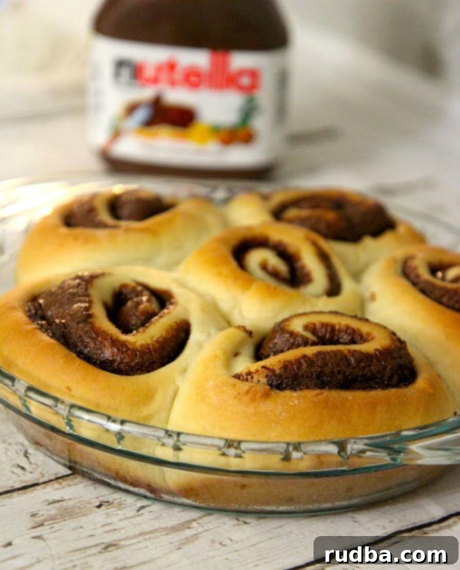 These homemade cinnamon rolls are filled with Nutella and baked to a golden brown perfection