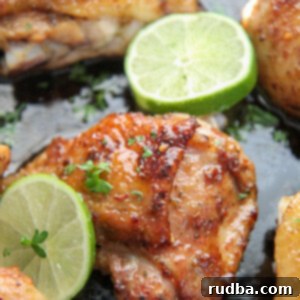 Honey Lime Glazed Chicken Thighs 6 bone in chicken thighs in a cast iron skillet with lime wedges