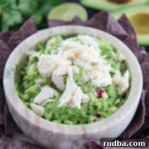 Zesty Crab Guacamole 6 Crab Guacamole in a bowl with tortilla chips on the side