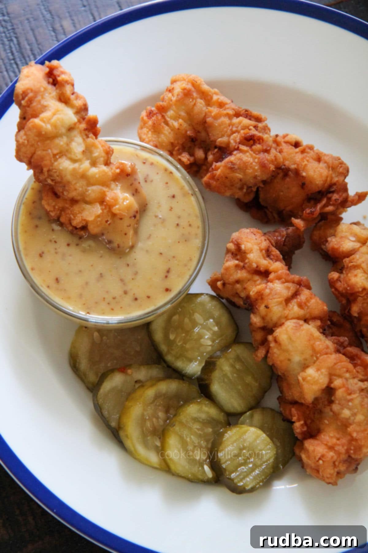 chicken and pickles with sauce on a white plate 
