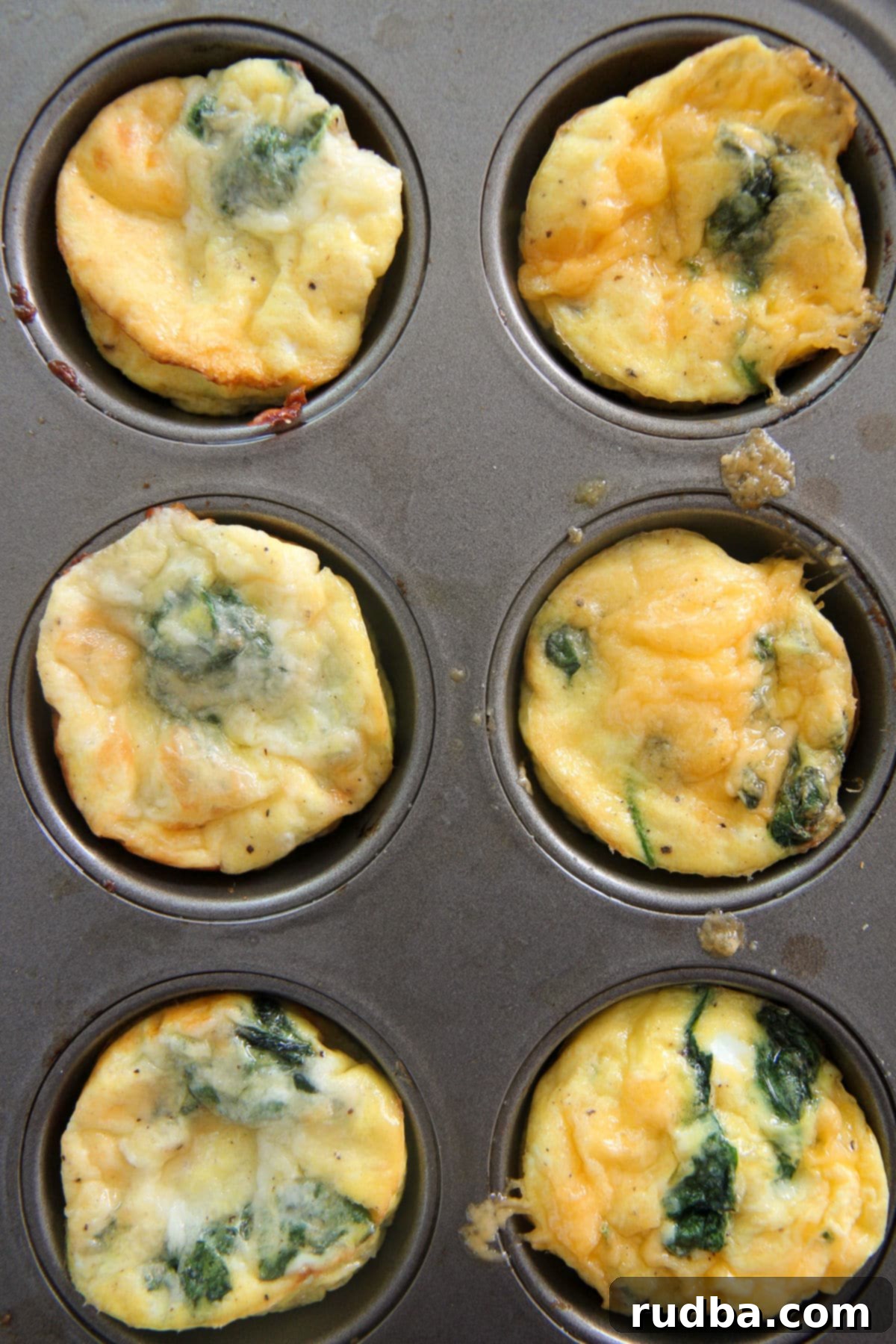 6 egg muffins in a muffin tin, golden brown and fluffy
