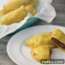 Jamaican beef patties in a basket and a white plate