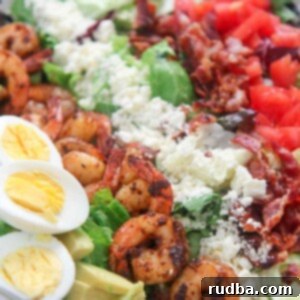 Deluxe Shrimp Cobb Salad 5 shrimp cobb salad with boiled eggs in a white plate