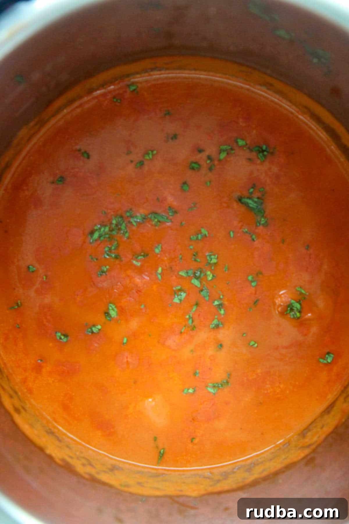 Creamy butter chicken with fresh cilantro garnish, served directly in the Instant Pot liner, ready to be dished out.