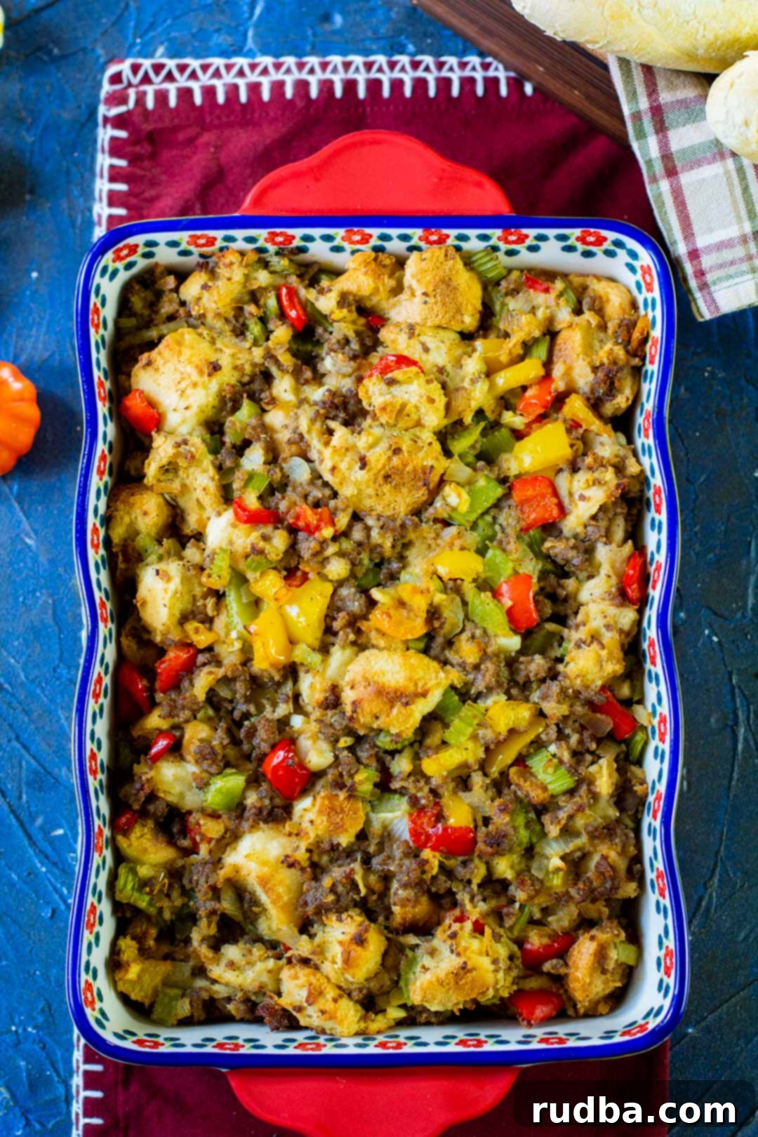 sausage stuffing in a blue and red casserole dish 