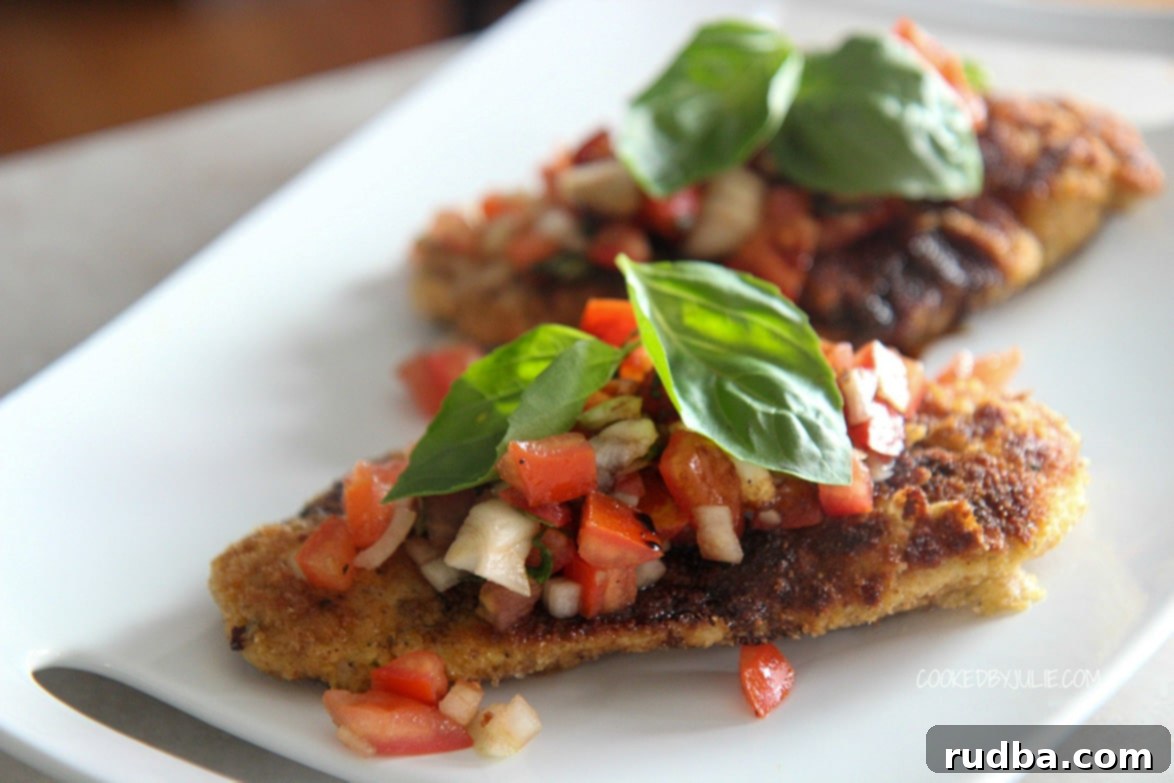 two servings of chicken bruschetta on a white plate.