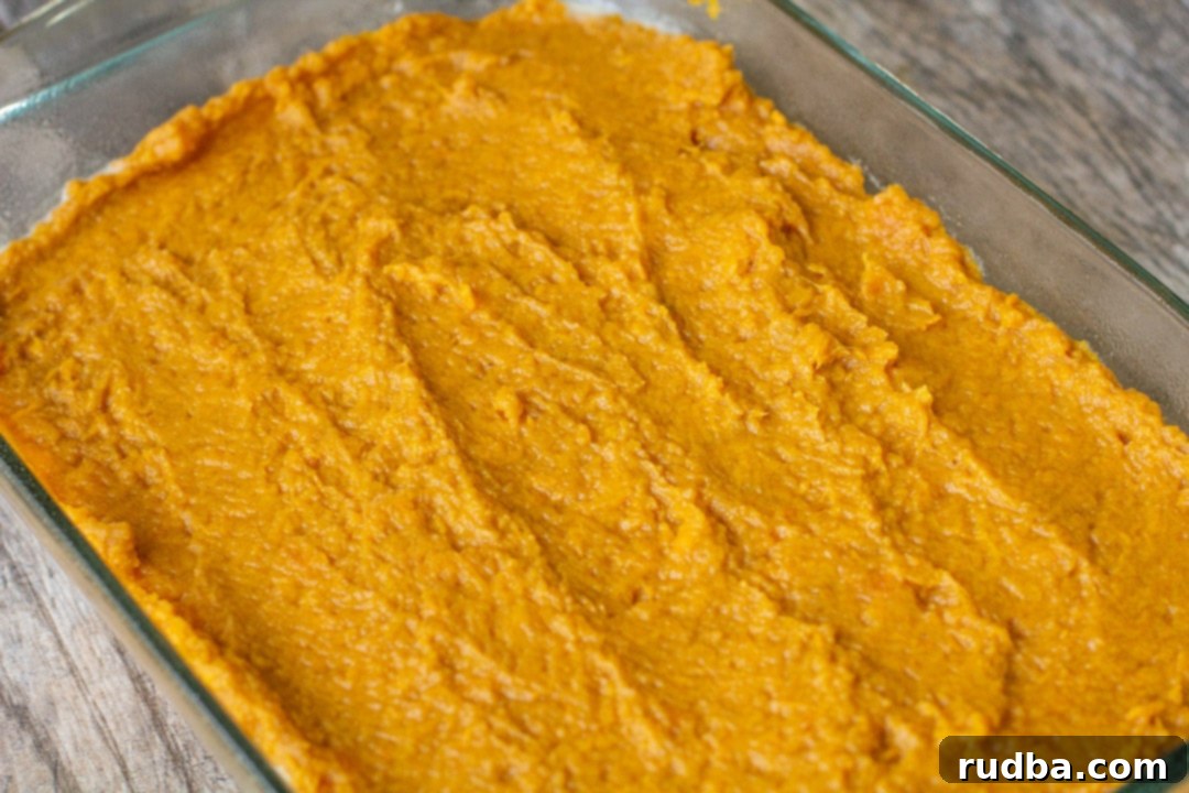 Layered mashed sweet potatoes in a glass baking dish