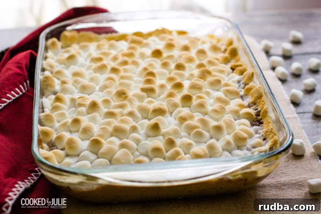 baked mini marshmallows in a glass baking dish with a red towel 