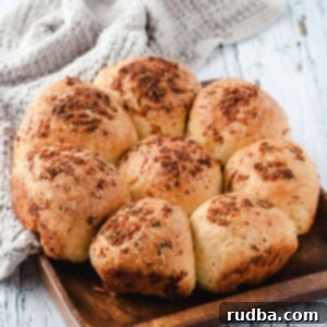 eight dinner rolls on a wooden board