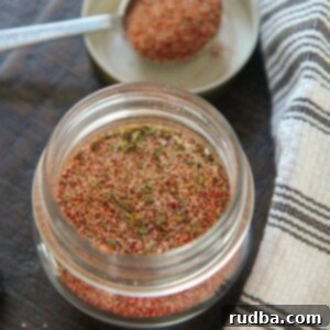 Soulful Cajun Blend 5 cajun seasoning blend in a small jar with a spoon