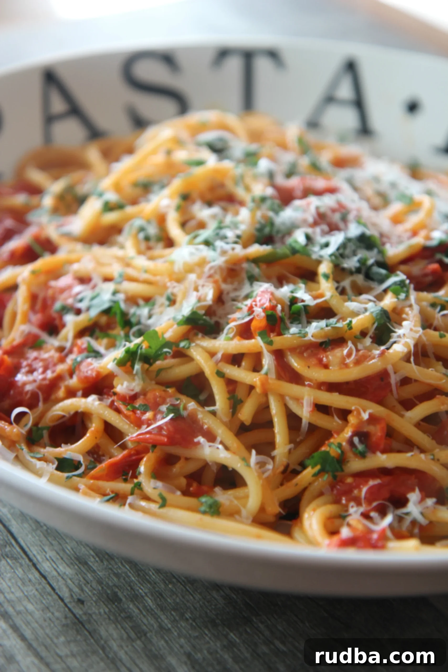 Freshly roasted grape tomatoes, tender bucatini pasta, and a light helping of mozzarella cheese make this a deliciously light and vibrant pasta dish