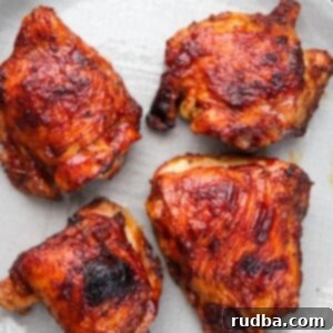 Fall-Off-The-Bone Oven BBQ Chicken 5 Four pieces of poultry on a plate