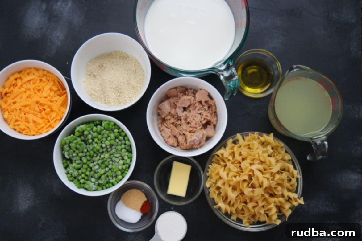 Thirteen small bowls containing all the ingredients for tuna noodle casserole, neatly arranged