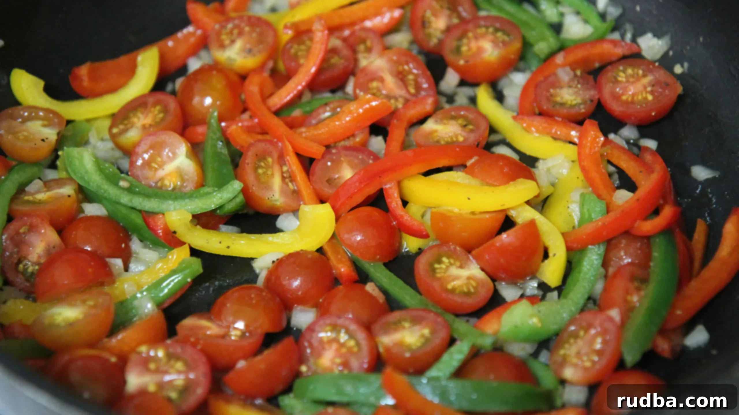 Toss your vibrant bell peppers and diced onions together in one pot, creating the aromatic base for your fajita pasta sauce.