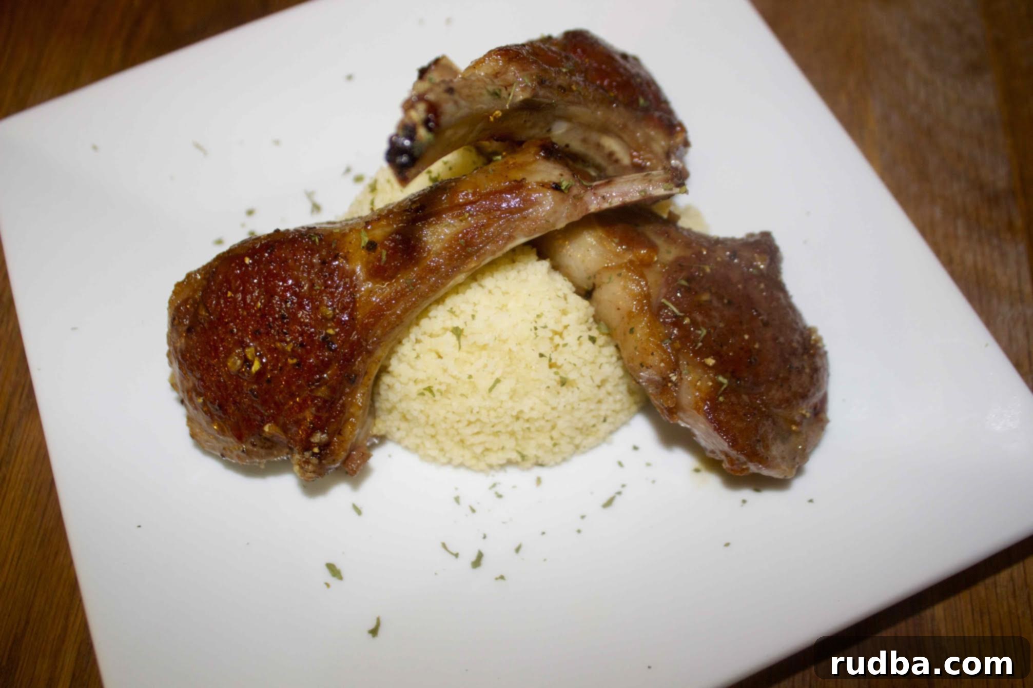 Tender honey garlic lamb chops served with a side of couscous