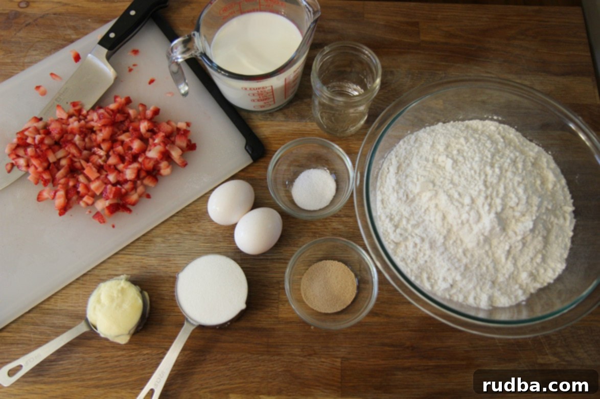 Ingredients laid out on a table: fresh strawberries on a chopping board, milk, eggs, flour, yeast, shortening, and sugar.
