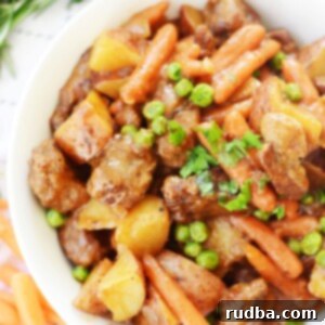 A perfectly portioned bowl of classic beef stew, garnished with fresh herbs.