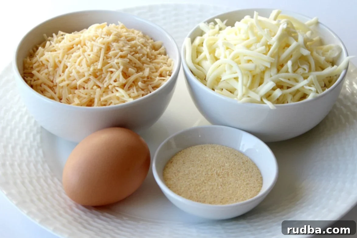 Close-up of the four simple ingredients: granulated garlic, shredded cheese, and a single egg on a plate, ready for mixing.