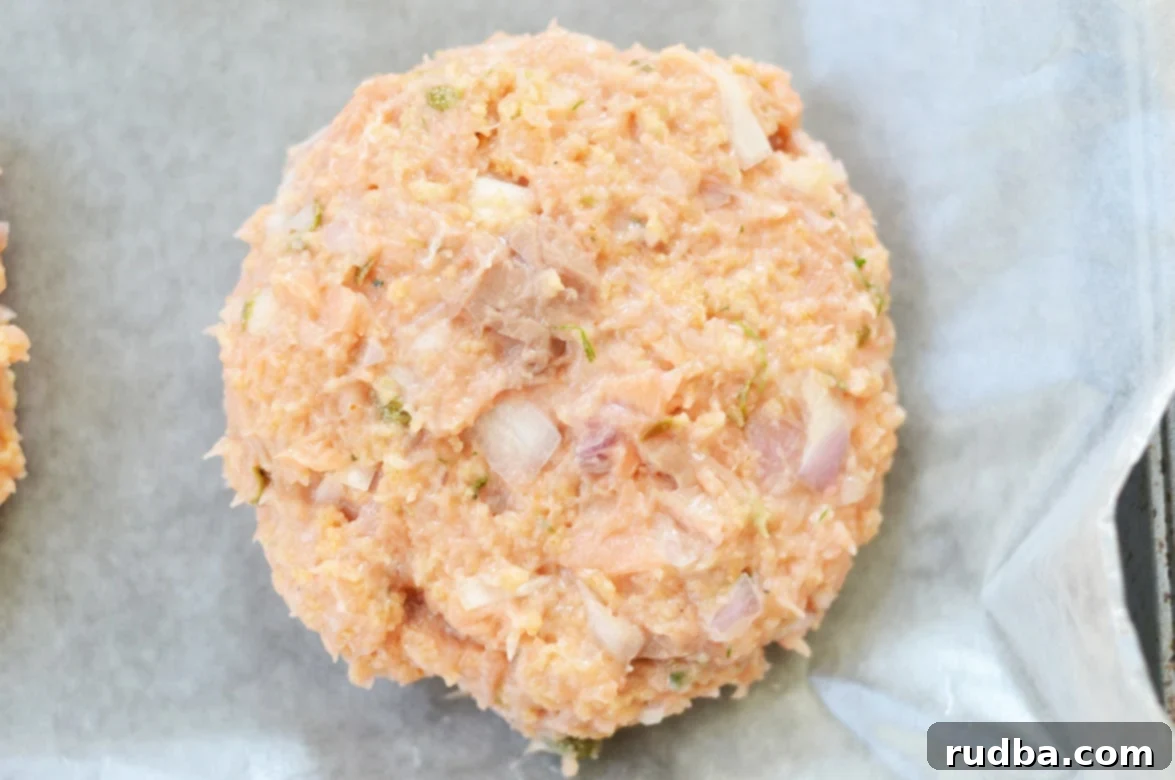 Uncooked salmon burger patty ready for the grill