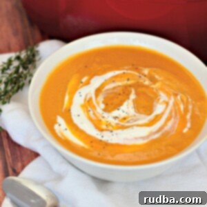 Creamy Roasted Butternut Squash Soup 5 roasted butternut squash soup in a white bowl with a spoon on the side