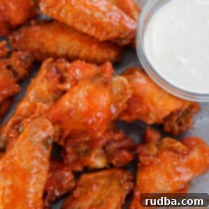 Crispy Oven Wings 4 baked buffalo wings on a gray plate with a side of bleu cheese