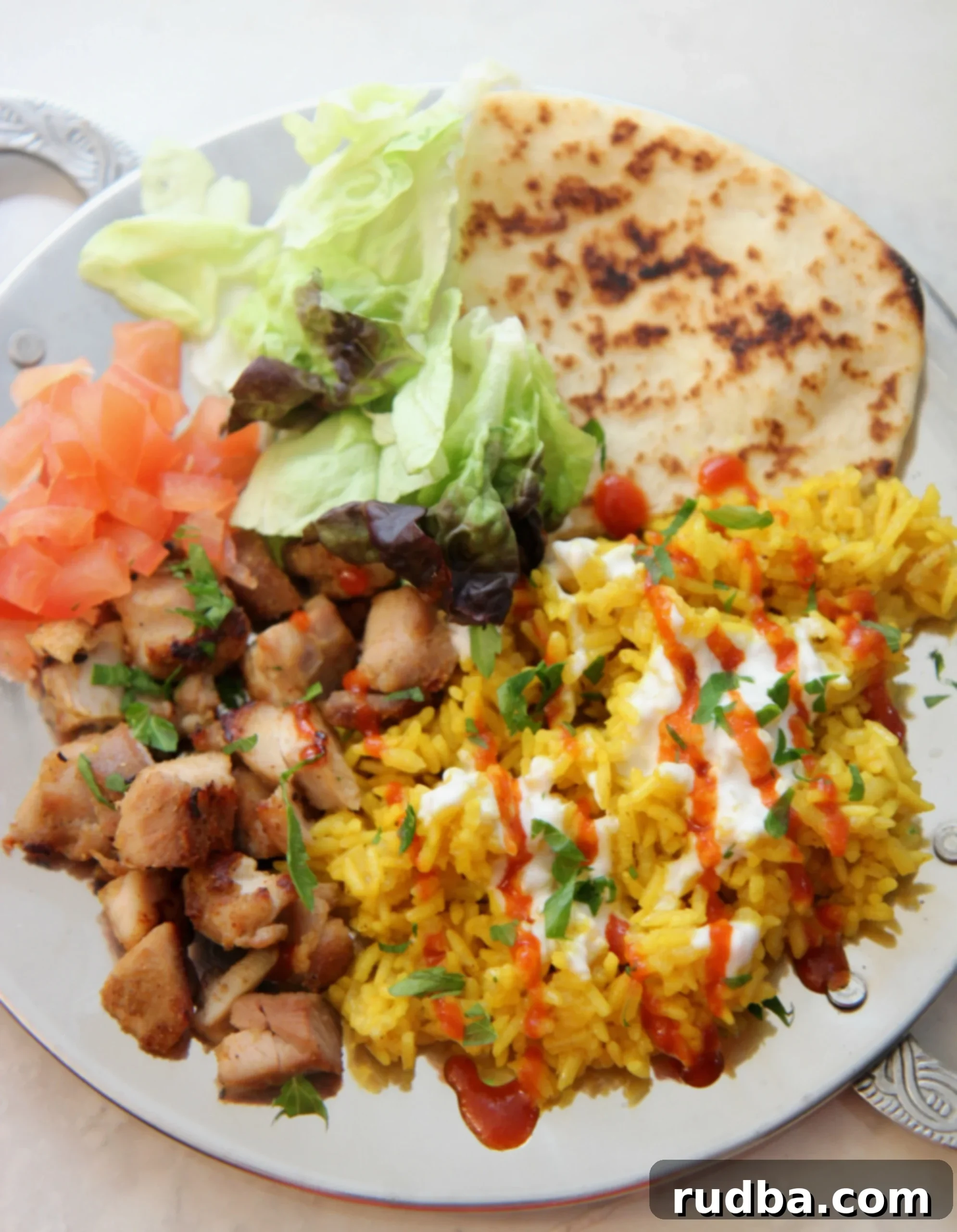 This Halal Guys chicken and rice recipe is similar to what you'd get at a lunch cart in NYC, featuring succulent chicken and flavorful yellow rice.