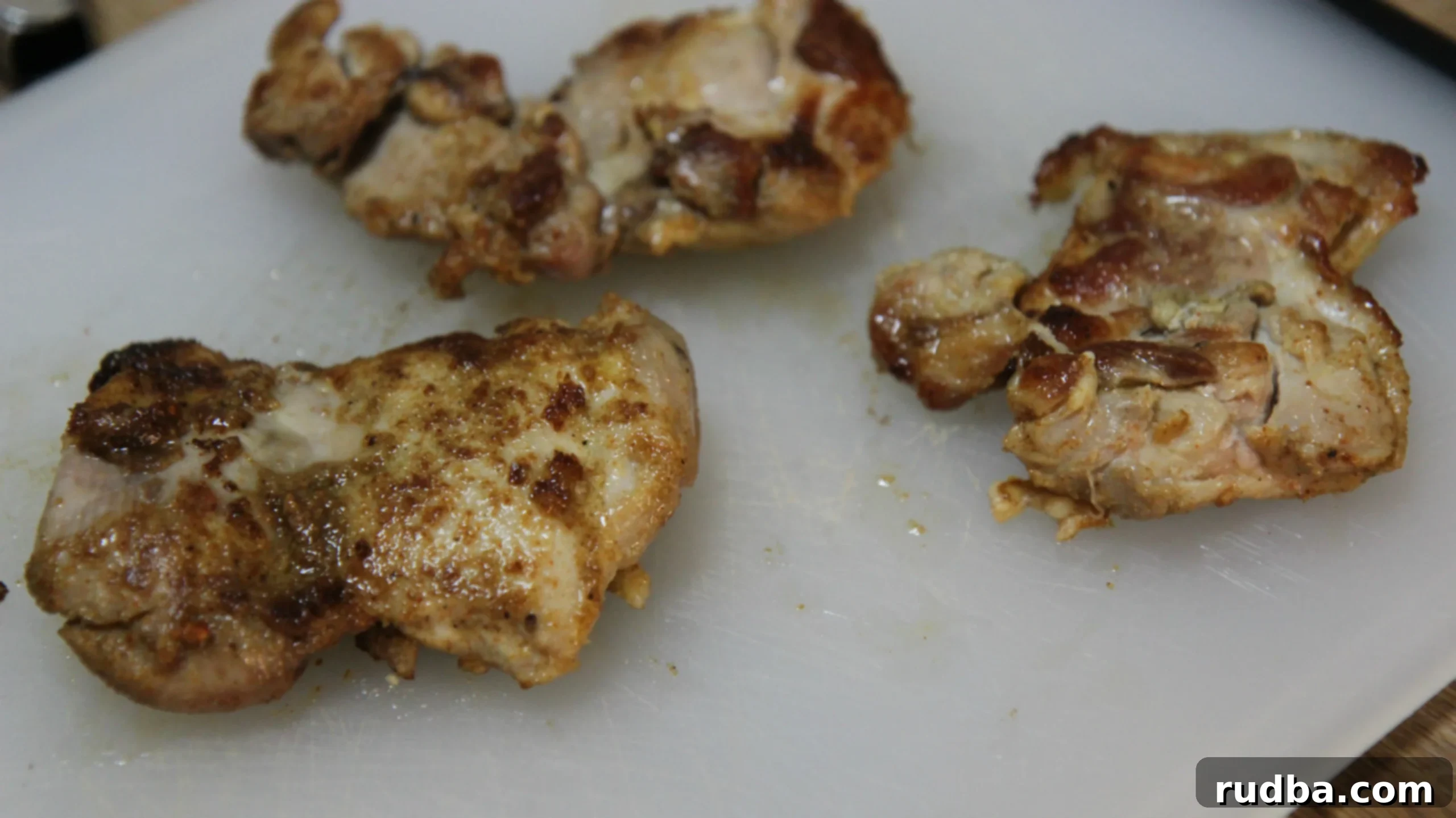 Perfectly seasoned chicken thighs, golden brown and juicy, ready for your homemade Halal Cart feast.