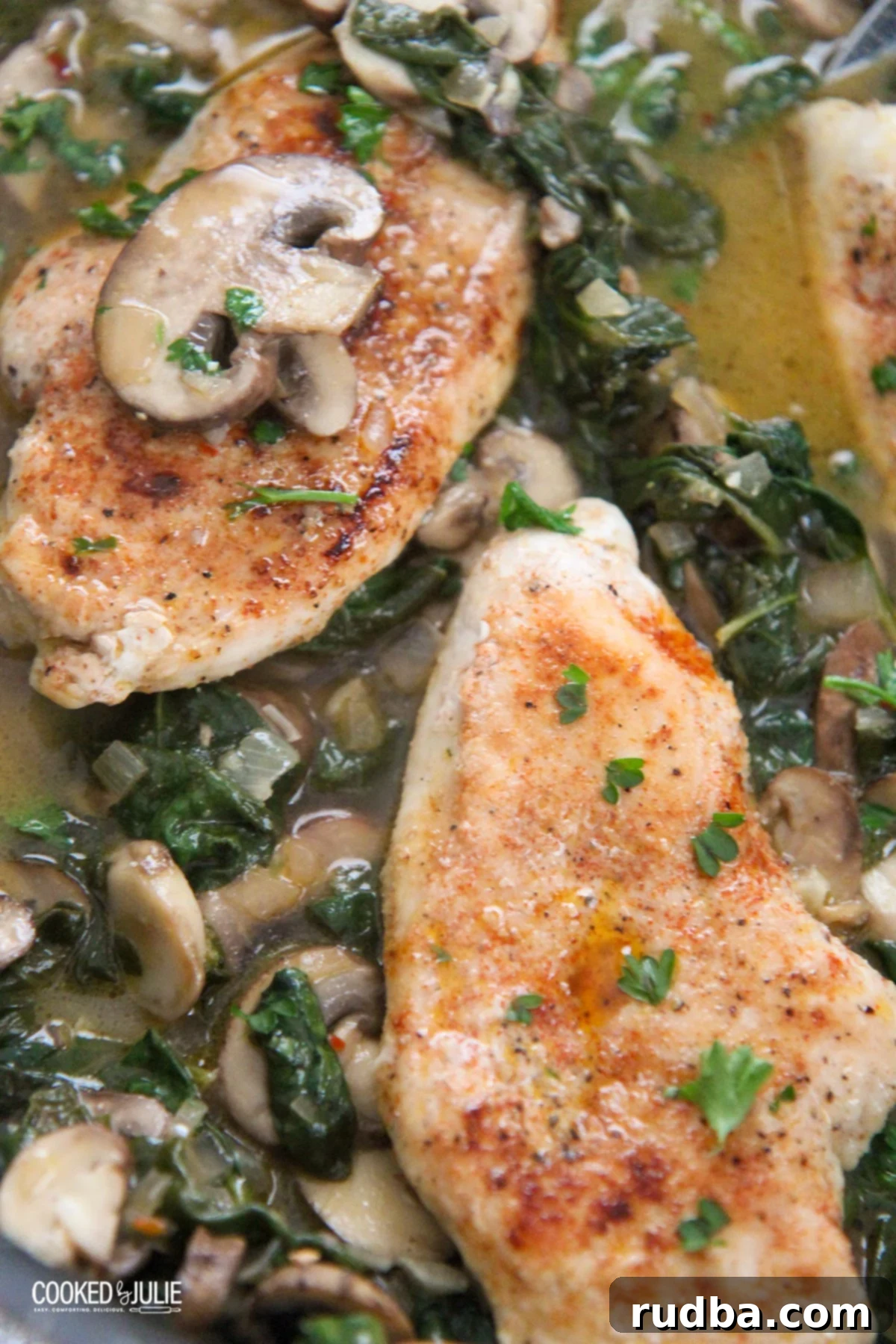 chicken, spinach, and mushroom in a skillet 
