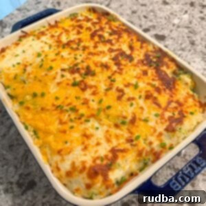 Cheesy Broccoli Rice Bake 4 broccoli rice casserole in a 9x9 blue baking dish.