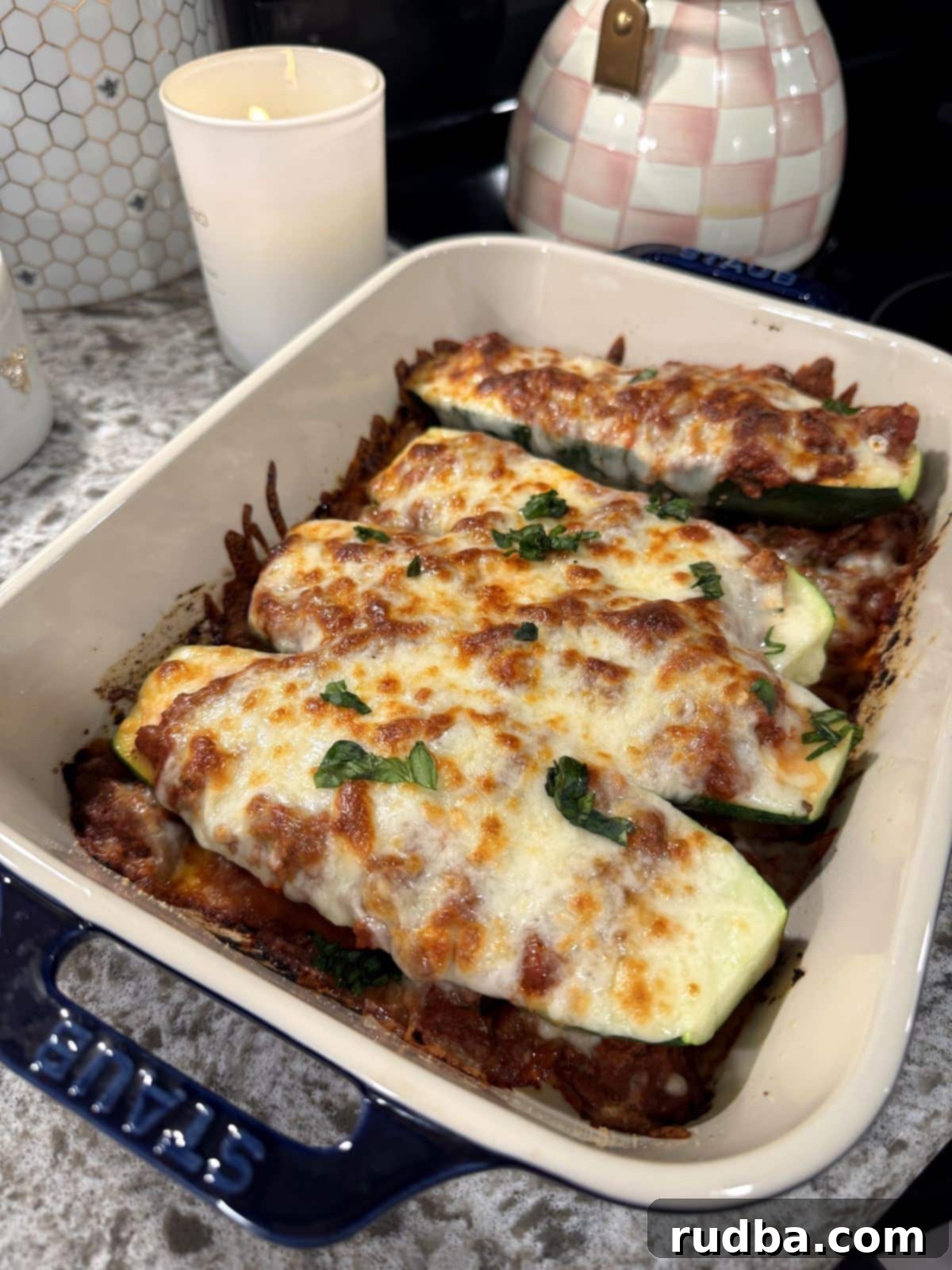 Lasagna-Filled Zucchini Vessels 2 Lasagna stuffed zucchini boats with meat sauce and melted mozzarella.