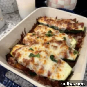 Lasagna-Filled Zucchini Vessels 5 Lasagna stuffed zucchini boats with meat sauce and melted mozzarella.