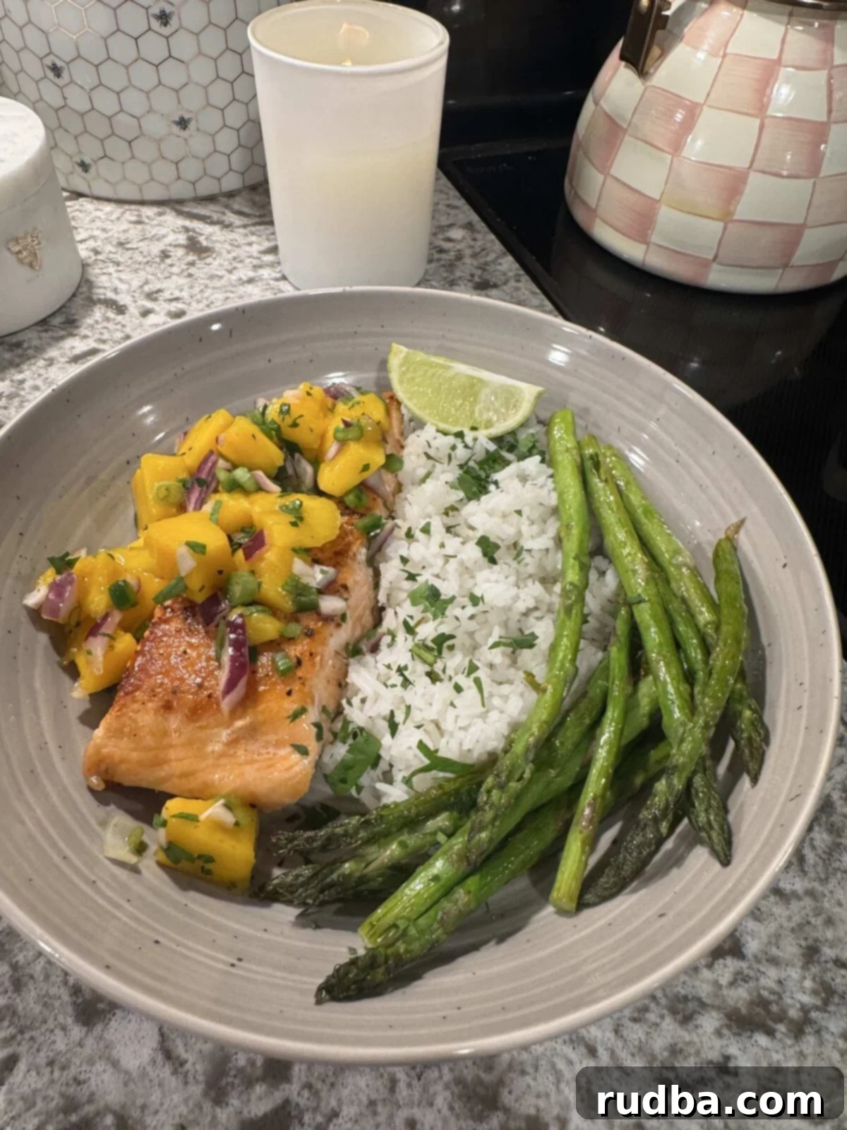 Mango Salmon Bowl
A Tropical Salmon Delight 2 Cooked salmon topped with mango salsa, served with rice, asparagus, and a lime wedge.