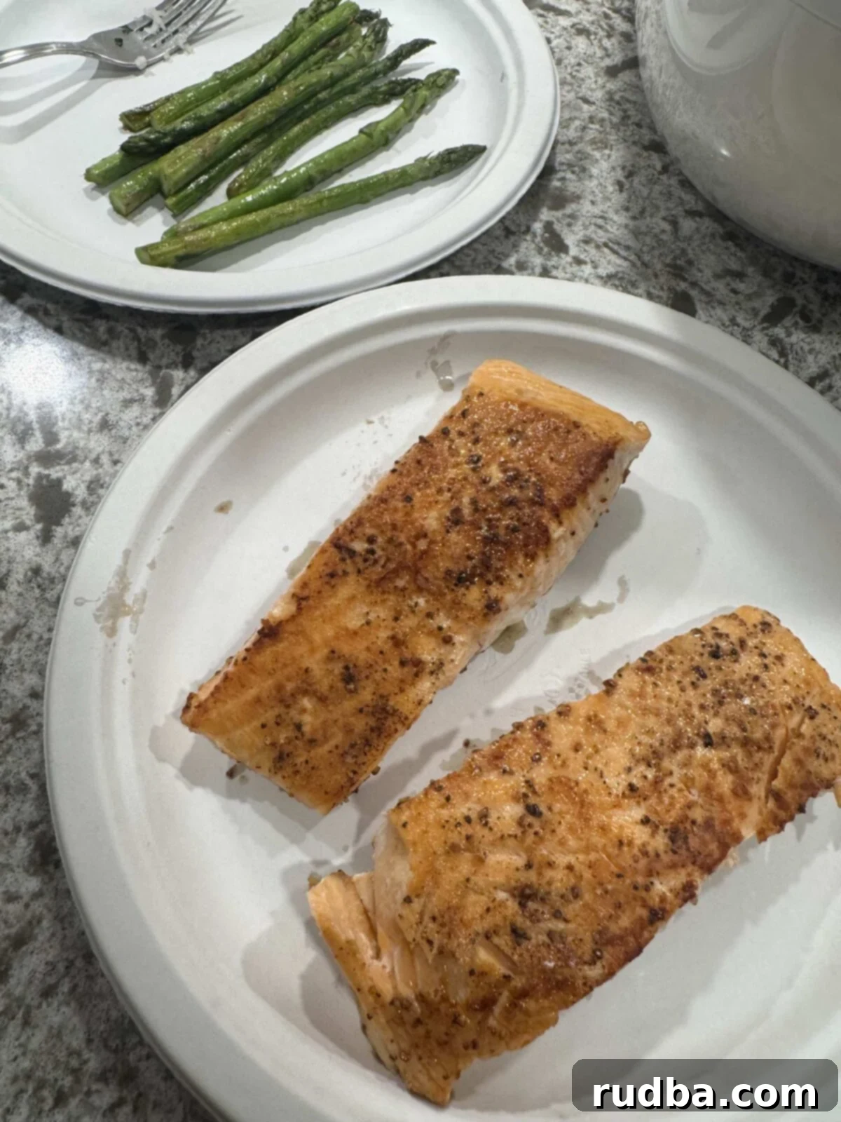 Mango Salmon Bowl
A Tropical Salmon Delight 3 Two salmon fillets in one plate and cooked asparagus in a separate plate.